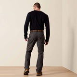 A man wearing Ariat Rebar M4 Low Rise DuraStretch Stackable Straight Leg Pant, showing the back view in a casual setting.