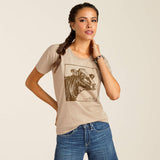 Woman wearing Ariat Cow Cover T-Shirt with cow print design, showcasing stylish and comfy everyday fashion.