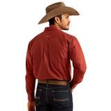A man wearing a red Ariat Sanders long sleeve shirt and cowboy hat, showcasing the shirt's detailed back design.