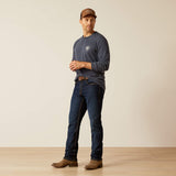 A man wearing the Ariat Saltillo Lockup T-Shirt, styled with jeans and boots, showcasing a casual western look.
