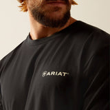 Close-up of a man wearing an Ariat Big Sky Freedom T-Shirt, showcasing the Ariat logo on a black shirt.