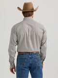 Back view of a man wearing a Wrangler George Strait long sleeve button down shirt with a cowboy hat and blue jeans.
