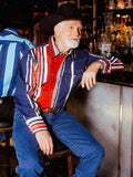 A man wearing a Wrangler® Brushpopper Western Snap Shirt in Americana red, white, and blue stripes at a bar.