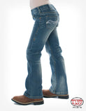 Girl wearing Cowgirl Tuff Don't Fence Me In jeans, showcasing medium wash denim with gold stitching.