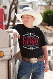 Boy wearing a Cinch Denim black short sleeve tee while leaning on a truck in a sunny outdoor setting.