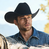 Stetson Corral 4X Cowboy Hat worn by a man in a denim shirt outdoors, showcasing classic Western style.