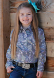 Cruel - Girl's Purple Paisley Snap Shirt featuring a smiling girl with long hair wearing the shirt against a wooden backdrop.
