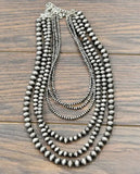 24" Handmade 6-strand Navajo Bead Necklace displayed on a wooden surface.