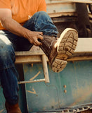 A person wearing Tecovas - LongHaul Waterproof Square Composite Toe Work Boot, showing the boot's detailed sole and design.