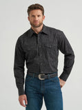 Wrangler Men's Black Paisley Print 20X Competition Advanced Comfort Snap Western Shirt model wearing denim jeans.