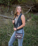 Model wearing the Guadalupe Serape Grace Crossbody bag showcasing fall colors, featuring STS Ranchwear design.