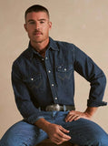 Man wearing Wrangler Cowboy Cut Work Shirt in dark denim, showcasing a stylish western look.