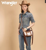 Model wearing Wrangler Genuine Cowhide Top Handle Fringe Crossbody bag in Brown with a western outfit and hat.