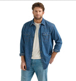 Model wearing a Wrangler denim long sleeve shirt in mid wash, showcasing classic style and comfort.