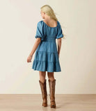 Ariat Women's Juliet Dress in light wash indigo, featuring puff sleeves and tiered design, styled with western boots.