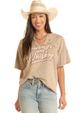 Model wearing Rock & Roll Cowgirl Cowboys & Whiskey graphic tee in olive with a cowboy hat and casual jeans.