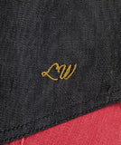 Detail of the Wrangler x Lainey Wilson Women's Black Denim Sleeveless Western Shirt showing the embroidered 'LW' logo.