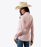 Ariat Women's Team Kirby Stretch Long Sleeve Shirt in pink stripes, worn with a cowboy hat, showcasing Greater Arm Mobility™ technology.