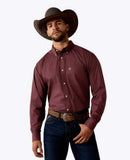 Ariat Men's Wrinkle Free Wrenly Classic Fit Long Sleeve Shirt in burgundy worn by a model with a cowboy hat.