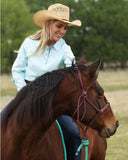 Cinch Women's Long Sleeve Arenaflex® Hybrid Shirt in light blue worn by a woman riding a horse.