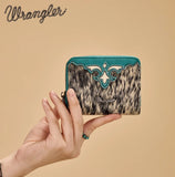 Wrangler Women's Genuine Hair-On Cowhide Zip-Around Wallet held in hand against a neutral background.