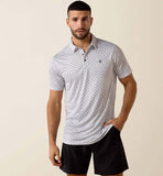 Ariat Men's All Over Print Fitted Polo with a sleek design worn by a model in casual shorts.