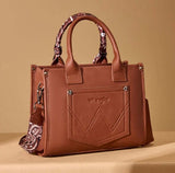 Wrangler Women's Brown Paisley Print Tote Crossbody Bag with embroidered details and whipstitch trim.