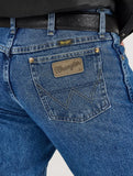 Close-up view of Wrangler Men's George Strait Cowboy Cut jeans showing iconic back pocket design and logo.