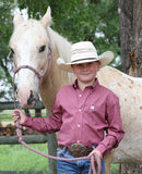 Cinch Toddler Boy's Long Sleeve Geo Print Western Shirt in dark pink, worn by a boy beside a white horse.