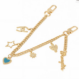 Wrangler Western multi-charm bag chain in light gold featuring vintage charms and lobster clasps.