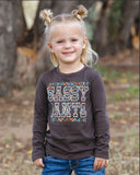 Cute toddler girl in Cruel Girl long sleeve shirt with 'Sassy Pants' graphic, perfect for western style adventures.
