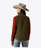 Ariat Women's Dilon 2.0 Reversible Insulated Vest in green, styled with a red shirt and cowboy hat, viewed from the back.