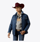 Ariat Women's Grizzly Quilted Barn Jacket in Midnight, styled with a western hat, perfect for cold weather.