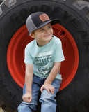 Cinch infant and toddler boys' graphic t-shirt worn by a boy sitting on a tractor tire, showcasing country style.