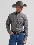 Man wearing a Wrangler George Strait long sleeve shirt, cowboy hat, and jeans, perfect for Western-style outings.