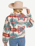 Back view of a woman wearing an Aztec print sherpa pullover with a beige hat.