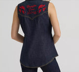 Back view of Wrangler Lainey Wilson x Embroidered Sleeveless Denim Shirt showcasing detailed red flame embroidery.