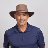 Man wearing an American Hat Makers Soaker Breathable Wide Brim Sun Hat, smiling against a neutral background.