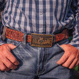 Montana Silversmiths Be the Future FFA Attitude Buckle worn by a person in denim and a plaid shirt.