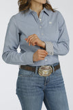 Cinch Women's Stretch Stripe Button-Down Western Shirt in blue, featuring a stylish design and patterned cuffs, paired with jeans and a belt.