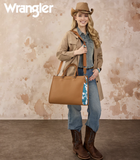 Woman wearing a cowboy hat and western attire, holding a Wrangler WG389-8119 brown tote bag against a textured background.