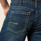 Close-up of the back pocket of Rebar M4 work jeans showcasing durable DuraStretch denim and Ariat branding.