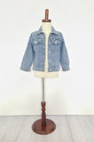 Kids Pearl Jean Jacket displayed on a mannequin, denim material with silver buttons and pearl embellishments.