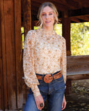 Cruel Denim women's long sleeve mesh top CTK7552001 in floral pattern, styled with jeans and a belt outdoors.