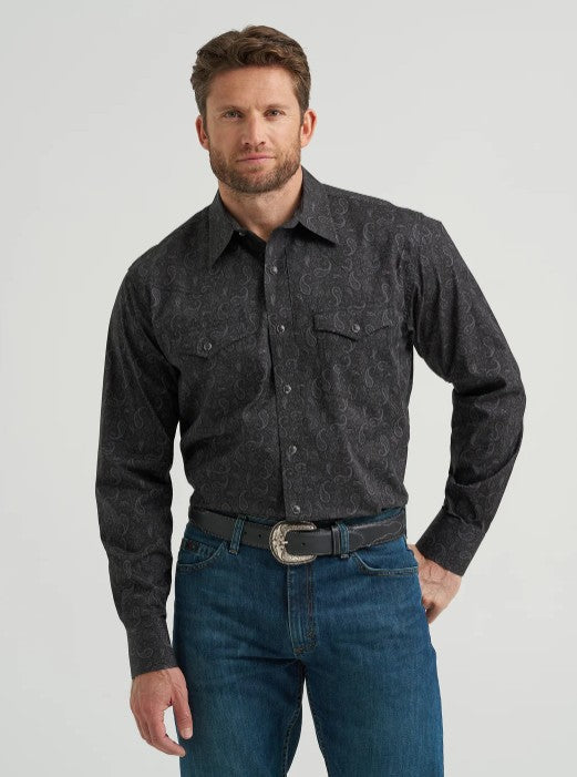Wrangler Men's Black Paisley Print 20X Competition Advanced Comfort Snap Western Shirt model wearing denim jeans.