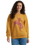 Woman wearing a Women's Wrangler Retro Crew Sweatshirt in Spruce Yellow with a unique graphic design.