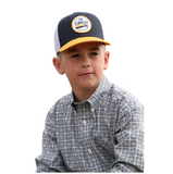 Cinch Youth Boy's Logo Patch Trucker Hat worn by a young boy in a stylish patterned shirt.