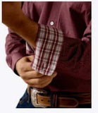 Close-up of a man adjusting the cuff of the Ariat Men's Wrinkle Free Wrenly Classic Fit Long Sleeve Shirt.