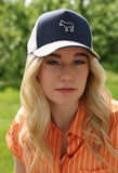 Cruel Girl Women's Aztec Donkey Snapback Trucker Cap with playful donkey graphic on a stylish model outdoors.