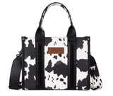 Wrangler Women's Cow Print Concealed Carry Tote & Crossbody Bag featuring durable PU leather and western style.